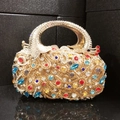 Detailed view of colorful peacock clutch bag featuring intricate rhinestones and gemstones - Gold Phoenix
