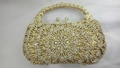 Detailed view of hollow floral pattern and crystal rhinestones on luxury evening clutch - Gold Feather Flower