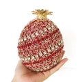Detailed close-up of a luxury pomegranate-shaped clutch bag with red crystal pavé - Pomegranate Shape / Red