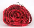 Macro view of red silk rose evening bag with layered petals and braided handle - Mixed Red