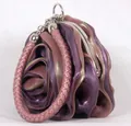 Detail view of purple silk rose evening bag featuring pink braided handle and metal frame - Mauve