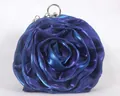 Detail of rose-shaped satin evening bag in electric blue with silver ring handle - Blue