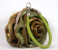 Detailed view of the layered rose petal fabric and silver metal clasp of the evening bag - Army Green
