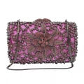 Close-up of fuchsia glitter evening clutch with intricate crystal flower and pink gems - Deep purple