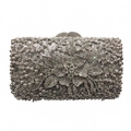 Detail of silver evening clutch featuring a large crystal floral motif and metal frame - Silver