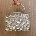 Close-up of luxury crystal evening clutch featuring teardrop rhinestones and metal ring handle - 19*13.5*7cm / Silver