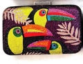 Close-up of hard shell evening clutch featuring toucan and tropical leaf crystal patterns - Toucan Pattern (Toucan) / Deep purple