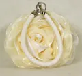 Macro detail of the cream-white 3D rose fabric texture and braided handle on this purse - Off White