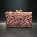 Detail of pink crystal evening bag featuring hollow metalwork and a bow clasp - Pink