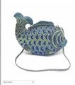 Macro view of blue-green rhinestone fish clutch showing exquisite crystal scales - Teal