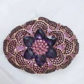 Macro detail of luxury dinner clutch featuring purple rhinestones and heart-shaped crystals - Purple