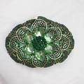 Detailed view of emerald green rhinestone evening clutch with heart-shaped crystal flower - Green