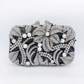 Detail of luxury rhinestone evening clutch bag with floral metalwork and silver crystals - Black With White Rhinestone
