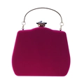 Macro shot of fuchsia velvet clutch bag with a large crystal clasp and gold ring handle - Rose Red