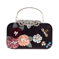 Close-up of black satin evening bag with 3D floral petals and jeweled bee accents - Black