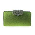 Macro shot of green sequined evening clutch bag with silver rhinestone crown clasp detail - Light Green