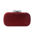 Detail view of a red sequin evening clutch featuring a diamond bow clasp and metal trim - Red