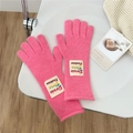 Detail of bright pink knitted gloves with brand label and long wrist guards - One Size / Deep Pink