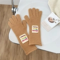 Close-up of camel knit gloves with detailed woolen texture and woven fashion label - One Size / Camel