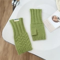 Close-up of grass green cable knit fingerless gloves with ribbed cuffs and leaf patterns - Emerald Green