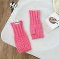 Detailed close-up of rose pink knit fingerless gloves with thumb hole and logo label - Deep Pink