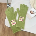 Close-up of light green knitted gloves featuring a fashionable colorful letter patch detail - One Size / Emerald Green