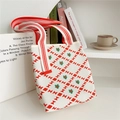 Close-up of a white knit tote bag featuring red bow patterns and floral details - Orange Hourglass Grid Flower (3) / 22cmx25cmx12cm
