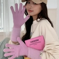 Detail of purple knitted gloves with pink faux fur trim and touch-screen finger openings - One Size / Purple
