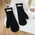 Detail shot of black faux shearling mittens featuring a minimalist brand woven label - Black