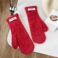 Detail of red plush mittens featuring thick sherpa fleece texture and brand label - Red