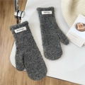 Detail shot of grey curly plush mittens showing thick warm texture and fashion woven label - Gray