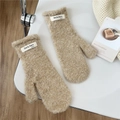 Detailed view of beige plush mitten texture with soft fleece and woven fashion label - Off White