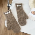 Close-up of thick coffee brown plush mittens with a minimalist white fabric tag detail - Dark Coffee