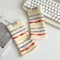 Close-up of knit fingerless gloves with colorful 3D fringe stripes on cream base - One Size / Fragmented Striped Milky White