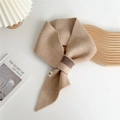 Detail of camel knitted winter scarf with cross-slot design and minimalist tag - 14x92cm / Khaki