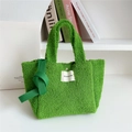 Detail of green faux shearling tote bag with brand label and knotted strap accent - Green