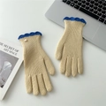 Close-up of knit glove with beige texture, blue wavy cuff and a white pearl button - Beige Contrast Scalloped Edge
