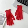 Detail of red knit gloves featuring white scalloped cuffs and elegant gold metal button - Red Contrast Scalloped Edge