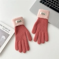 Close-up of pink and red ribbed knit gloves with fuzzy cuffs on a white desk setup - One Size / Deep Pink