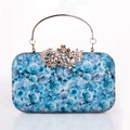 Detail of light blue rose print clutch with silver metal handle and rhinestone floral clasp - Blue