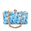 Detailed view of floral rose print clutch with crystal-encrusted flower clasp and gold chain - Blue