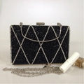 Detail of black evening clutch with silver rhinestone diamond pattern and metal handle - Black