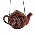 Macro detail of crystal teapot evening bag with bird and flower rhinestone patterns - Brown