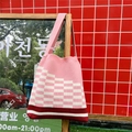 Detail of pink and white checkered knit tote bag showing soft cotton texture and strap - Pink Checkerboard