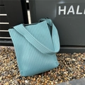 Detail of mint green pleated knit tote bag with vertical stripes and woven texture - Mint Green