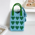 Detail of blue knitted mini bag showing green heart patterns and green top handles - 11*25cm / Blue With Green Heart
