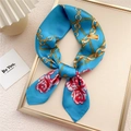 Blue silk-like scarf featuring golden chain and red rose patterns in a gold tray - Rose Gold Chain Lake Blue