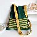 Detail view of the green pleated knit tote bag with contrasting yellow shoulder strap - Green and Yellow Half Stripe