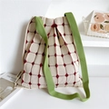 Close-up of pleated knit tote bag featuring red diamond pattern and green shoulder straps - Beige Small Polka Dot Grid