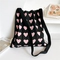 Detail of pleated knit tote bag with pink heart patterns and wide black strap texture - Black with Pink Solid Heart